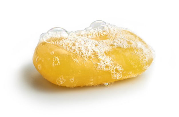 Yellow soap bubble of isolation on a white background